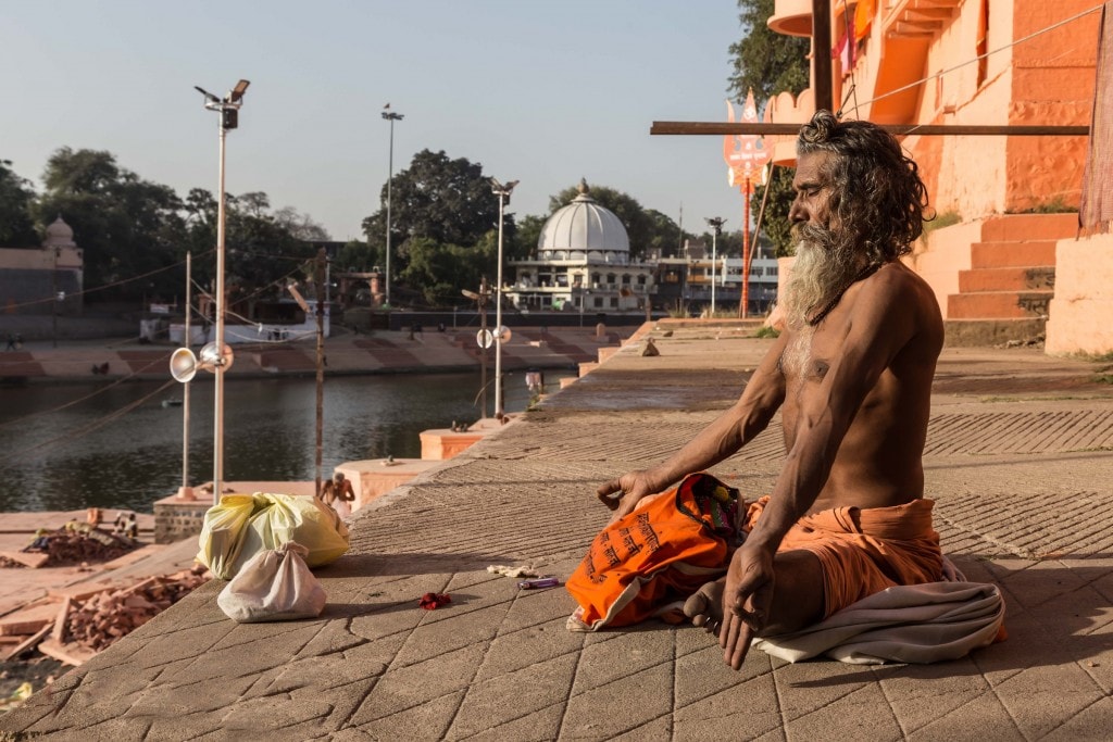 A hermit meditating at a ghat